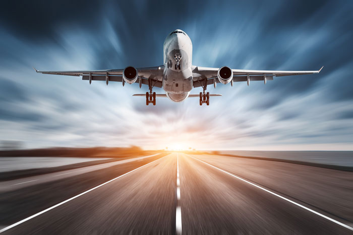Airplane and road with motion blur at sunset